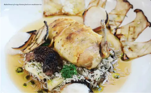  ??  ?? Baked breast of crispy Guinea fowl over mushroom rice