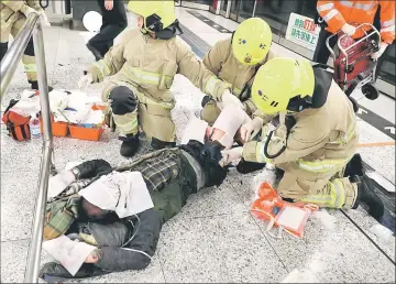  ??  ?? An injured person is under medical treatment inside a subway station in Hong Kong, China. — Reuters photo