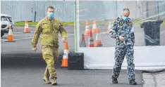  ?? Picture: JAY TOWN ?? AT THE READY: The ADF helps set up a testing facility at a Colac sports ground.