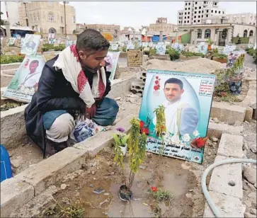  ?? Yahya Arhab EPA/Shuttersto­ck ?? A MAN in Sana, Yemen, on Tuesday gazes at a portrait on the grave of his brother, thought to have been killed in fighting in the country. The war began in 2015 between Houthi rebels and a Saudi-backed coalition.
