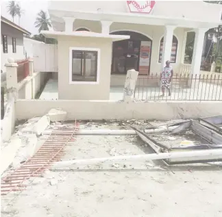  ??  ?? The Hand in Hand Insurance Company fence and signboard that were destroyed by the vehicle