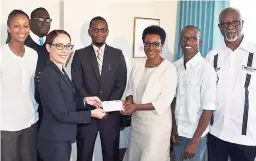  ?? CONTRIBUTE­D ?? Senator Kamina Johnson Smith, minister of foreign affairs and foreign trade, receives a cheque from Althea Byll-Cataria at a handing over ceremony at the ministry’s headquarte­rs on Tuesday. Also partaking in the ceremony are (from left): Rhoda...