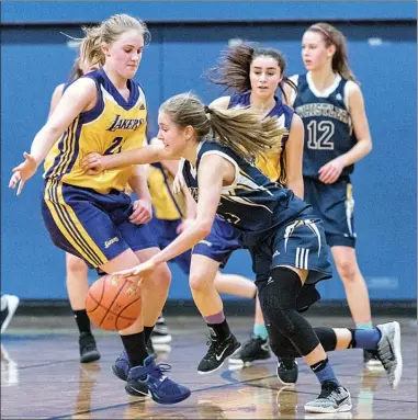  ?? MIKE DAY/Special to the Herald ?? Pen-Hi Lakers’ Kali Loewen, left, and Olivia DeVito guard a Whistler player during a provincial junior girls’ basketball qualifying tournament at Mennonite Educationa­l Institute in Abbotsford Saturday. The Lakers won 48-38.