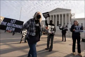  ?? MANUEL BALCE CENETA — THE ASSOCIATED PRESS ?? Myra Slotnick of Provinceto­wn, Mass., holds placards in front of the U.S. Supreme Court on Thursday in Washington.