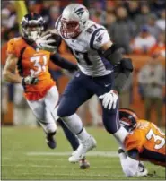  ?? JACK DEMPSEY — THE ASSOCIATED PRESS ?? New England Patriots tight end Rob Gronkowski (87) is hit by Denver Broncos strong safety Justin Simmons (31) during the second half of an NFL football game, Sunday in Denver.