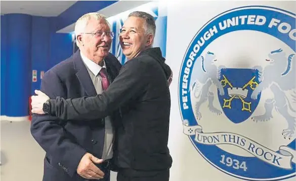  ?? ?? Posh boss Darren Ferguson is greeted by his father Sir Alex after the win at Wembley. Photo courtesy of the EFL.