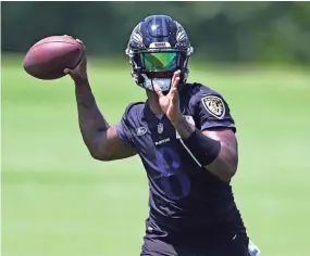  ?? GAIL BURTON/AP ?? Ravens quarterbac­k Lamar Jackson throws a pass during drills at the team’s practice facility June 15 in Owings Mills, Md.