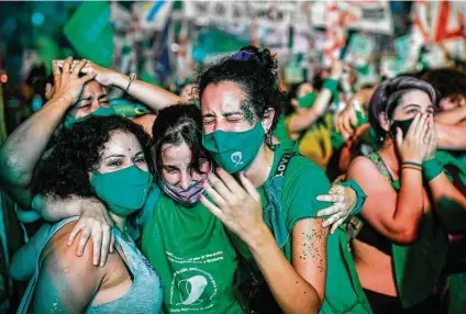  ?? Ronaldo Schemidt / Getty Images ?? Pro-choice activists celebrate after the Senate approved a bill to legalize abortion outside the Congress in Buenos Aires. Argentina on Wednesday became the largest nation in Latin America to legalize abortion.