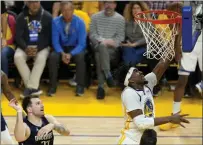  ?? THEARON W. HENDERSON — GETTY IMAGES ?? The Warriors' Kevon Looney (5) drives to the basket against the Mavericks' Luka Doncic (77) during the second quarter of Game 2of the Western Conference finals against the Mavericks in San Francisco on Friday.