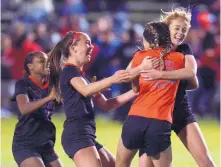  ?? GREG SORBER/JOURNAL ?? Sandia goalkeeper Charlee Wimberly (in red) embraces Sandia teammates (from left) Sapirah Broussard, Hannah Gallegos and Kaitlin Mack after the Matadors won the shootout and beat La Cueva.