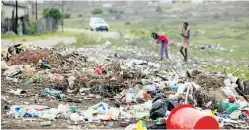  ??  ?? UNHEALTHY SITUATION: Children browse at an illegal dump site on the corner of Tulwana and Ngeni streets in Langa, Uitenhage