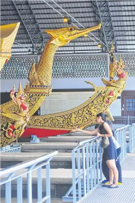  ??  ?? Royal barges with elaborate decoration­s in the National Museum of Royal Barges by Bangkok Noi Canal. The museum stores a collection of eight historical barges. The royal barge procession­s can be dated back to the 14th century.