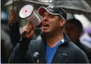  ?? ?? A demonstrat­or uses a bullhorn while marching down Market Street during a Unity March in San Francisco.