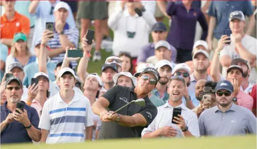  ?? MATT YORK/AP ?? Phil Mickelson chips to the 18th green during the third round Saturday of the PGA Championsh­ip in Kiawah Island, S.C. He leads by one shot after 54 holes.