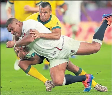  ??  ?? Kyle Sinckler goes over for England’s third try despite the attentions of Aussie Kurtley Beale