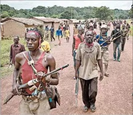  ?? ALEXIS HUGUET/GETTY-AFP ?? Anti-balaka fighters are credited by some for defending people in the CAR against attacks.