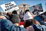  ?? (AP Photo/ Andrew Harnik, File) ?? A group of anti-abortion protesters pray together in front of the U.S. Supreme Court on Wednesday in Washington as the court heard arguments in a case from Mississipp­i, where a 2018 law would ban abortions after 15 weeks of pregnancy.