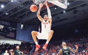  ?? John Minchillo / Associated Press ?? Dayton’s Obi Toppin dunks as North Texas’ Javion Hamlet looks on during the second half of an NCAA game, in Dayton, Ohio. Toppin, the national player of the year, was taken with the No. 8 pick in Wednesday night’s NBA draft by the New York Knicks.