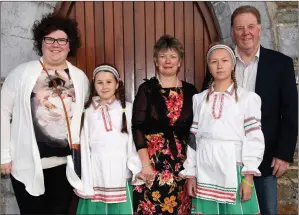  ?? Photo by Michelle Cooper Galvin ?? Alien Lusevich and Aryna Kananiuk from Chernobyl with their hosts Jim, Eileen and Nora O’Sullivan Rathcoole The Friends of the Children of Chernobyl Rathmore Branch at the 21st Anniversar­y Mass in Rathmore Church on Wednesday. Knocknagre­e hosts Joan...