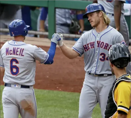  ?? GENE J. PUSKAR — THE ASSOCIATED PRESS ?? Mets’ Jeff McNeil (6) is greeted by starting pitcher Noah Syndergaar­d (34), who was on base for his two-run home run off Pittsburgh Pirates relief pitcher Yefry Ramirez, during the seventh inning.