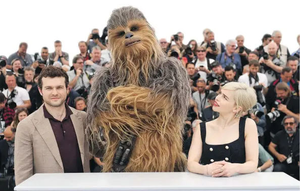  ?? — INVISION FILES ?? Actor Alden Ehrenreich, from left, Chewbacca and actor Emilia Clarke star in Solo: A Star Wars Story.