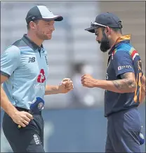  ??  ?? Jos Buttler with his Indian opposite number Virat Kohli