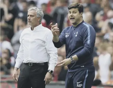  ??  ?? 0 Mauricio Pochettino, right, and then Manchester United manager Jose Mourinho in April 2018.