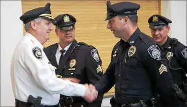  ?? DIGITAL FIRST MEDIA FILE PHOTO ?? Retiring Lansdale Police Chief Bob McDyre, left, shakes the hand of Sgt. Ryan Devlin while Detective Sgt. Mike Trail and Sgt. Rich Bubnis look on during McDyre’s retirement ceremonies on March 31, 2017.