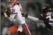  ?? MATT GENTRY - POOL, POOL THE ROANOKE TIMES ?? Clemson’ Trevor Lawrence runs for a 17-yard touchdown past Virginia Tech’s Brion Murray during the first quarter of an NCAA college football game Saturday, Dec. 5, 2020, in Blacksburg, Va.