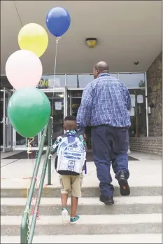  ?? Tyler Sizemore / Hearst Connecticu­t Media file photo ?? A father walks his son into school on the first day back at Northeast School in Stamford in 2015.