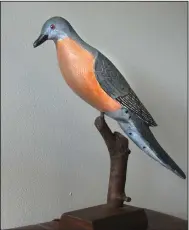  ??  ?? The Garland County Library owns “Passenger Pigeon” along with three other works donated by Iowa bird carver Dean S. Hurliman. (Special to the Democrat-Gazette/Jerry Butler)