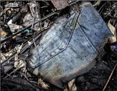  ??  ?? Belongings: A charred fragment of a pair of jeans