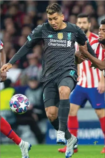  ??  ?? Liverpool’s Roberto Firmino in action against Atletico Madrid.