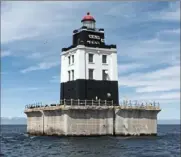  ?? U.S. General Services Administra­tion ?? Poe Reef Light, located 6 miles east of Cheboygan, Mich., is one of three historic Great Lakes lighthouse­s that have been put up for sale by auction by the federal government. The 56-foot light marks a shallow reef for ships heading west to Lake Michigan and guides ships safely through this hazardous channel in Lake Huron.