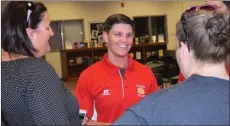  ?? Noah Syverson / RN-T ?? New Rome High softball coach Emily Herren shares a laugh with parents at a meet-and-greet in the Rome High media center on Thursday.