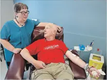  ?? CLIFFORD SKARSTEDT EXAMINER ?? Jim Rees gives blood for his 252nd donation next to his wife Linda on Thursday at the Canadian Blood Services clinic on George St.