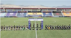  ??  ?? Players for the Portland Thorns, left, and the North Carolina Courage kneel to show support for Black Lives Matter and to protest racial injustice ahead of their NWSL Challenge Cup match on Saturday in Herriman, Utah.