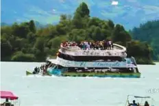  ?? Reuters ?? A tourist ferry sinks in the Guatape reservoir in Colombia, on Sunday, in this still image taken from video obtained from social media.