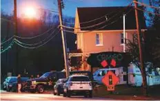  ?? AP ?? A coroner’s unit pulls away as police operate at a crime scene outside the Cameo Nightclub after a reported fatal shooting yesterday in Cincinnati.