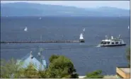  ??  ?? In this Aug. 14, 2015 file photo, sail boats and a passenger ferry dot Lake Champlain as seen from Battery Park in Burlington, Vt. Two decades after the diminutive lake was ridiculed when it was briefly listed as one of the Great Lakes in 1998, a...