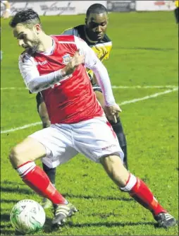  ?? Picture: Les Biggs ?? Whitstable’s Danny Williams holds off a Croydon challenge during Tuesday’s 4-0 win in the Challenge Cup