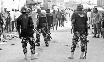  ??  ?? Federal Special Anti-Robbery Squad (FSARS) check disturbanc­es by hoodlums at a polling station in Kano, the commercial capital of northern Nigeria. — AFP photo