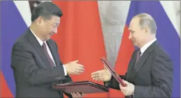  ??  ?? Russian President Vladimir Putin, right, and Chinese President Xi Jinping shake hands during a signing ceremony following talks in the Kremlin, Moscow, on expanding co-operation and jointly building an “Ice Silk Road”. Xi urged the two countries to...