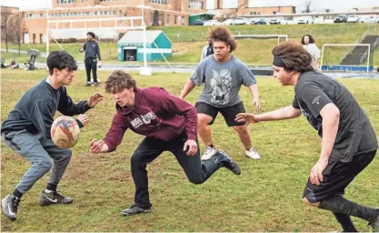  ?? PHOTOS BY RICK CINCLAIR/TELEGRAM & GAZETTE ?? Doherty High junior Ben Gniadek, center, tosses the ball during a recent WPS rugby practice.