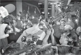  ?? Robert Gauthier Los Angeles Times ?? THE UCLA PLAYERS couldn’t avoid all the cameramen and reporters upon returning to Los Angeles, and they were bombarded with questions.