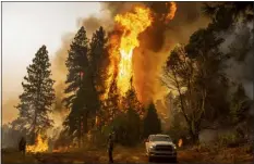  ?? NOAH BERGER — THE ASSOCIATED PRESS FILE ?? A firefighte­r monitors a backfire, flames lit by fire crews to burn off vegetation, while battling the Mosquito Fire in the Volcanovil­le community of El Dorado County on Sept. 9.