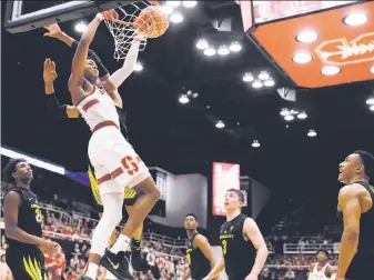  ?? Marcio Jose Sanchez / Associated Press ?? Stanford forward KZ Okpala dunks against Oregon in the second half of the Cardinal’s 35-point rout at Maples Pavilion. Okpala, a freshman, scored 20 points, including two three-pointers.