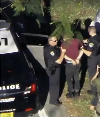  ??  ?? Police officers arrest a suspect after the shooting at Marjory Stoneman Douglas High School in Parkland Florida. (Top left) Medics attend to a shot student. (Far left) A student is overcome with emotion after being released from a school lockdown.