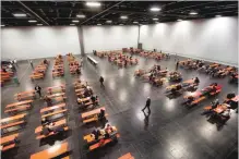  ?? — AFP ?? People wait in a fair hall during an evacuation on Sunday in Augsburg, southern Germany.