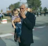  ?? (Ibraheem Abu Mustafa/Reuters) ?? THE FATHER and son of assassinat­ed alleged weapons expert Fadi al-Batsh are present as his body arrives in the southern Gaza Strip yesterday.